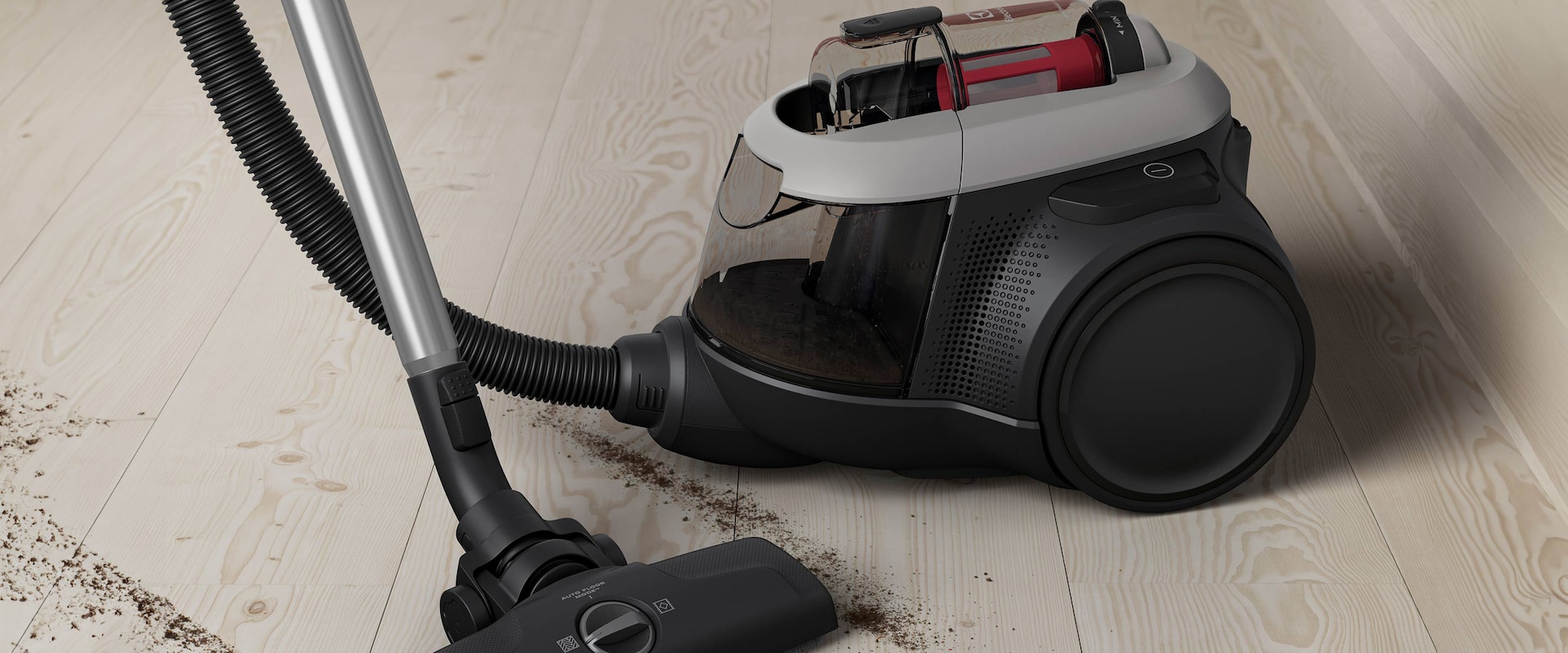 En poseløs støvsuger står på et gulv.